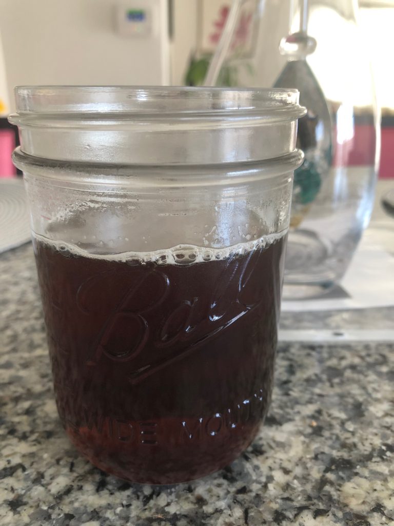 Finished  Chamomile-Lavender Syrup in a mason jar for storage.