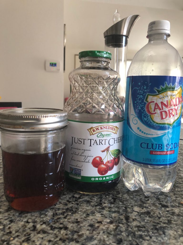 Image of jar of Chamomile-Lavender Syrup and bottles of tart cherry juice and club soda 